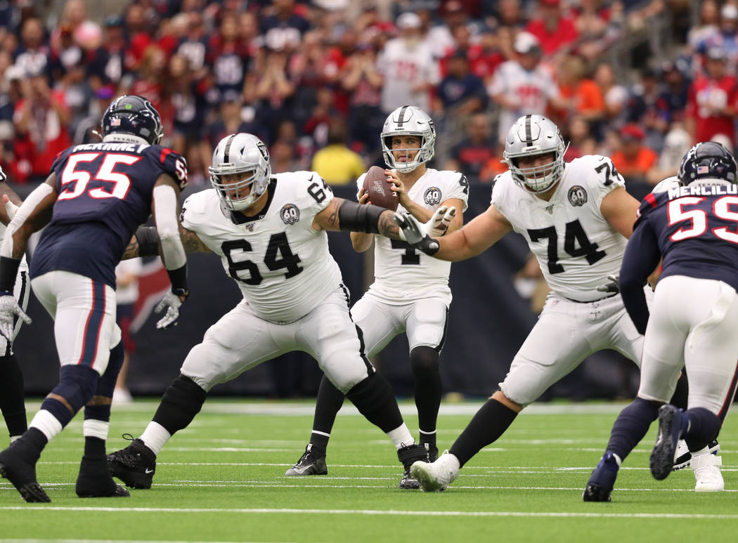 Oakland Raiders quarterback Derek Carr (4) drops back to pass as offensive guard Richie Incogni ...