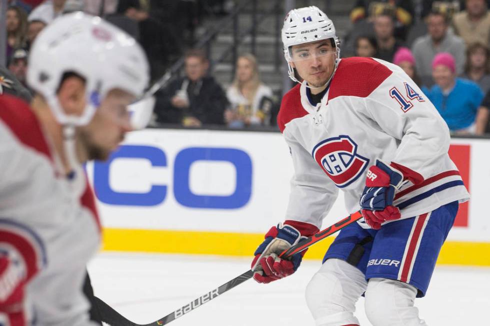 Montreal Canadiens center Nick Suzuki (14) skates up ice in the first period during an NHL hock ...