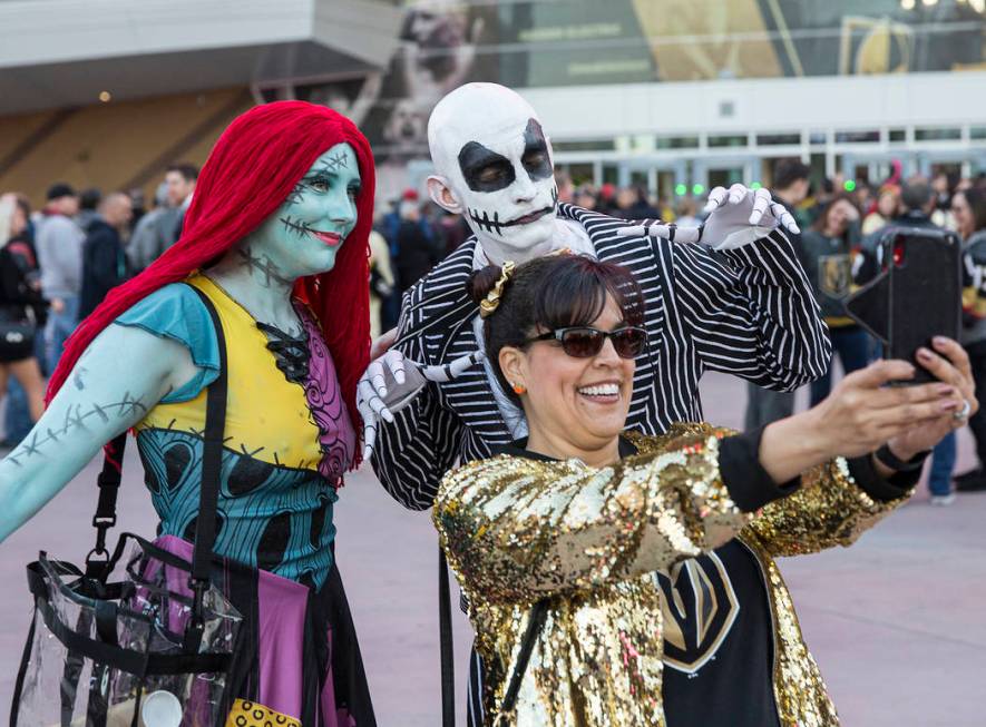 Kara Caldwell, left, and Jay Bryant-Chavez take a selfie with Denise Soto outside T-Mobile Aren ...