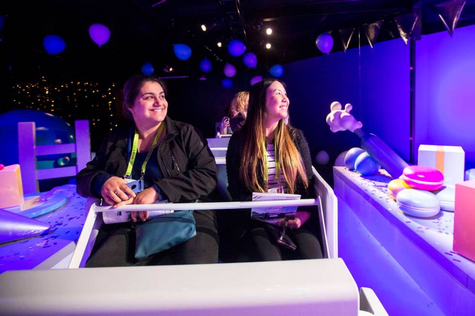 Attendees Azin Biatani, left, and Sabrina Nguyen, with the Fullerton College in Calif., take a ...