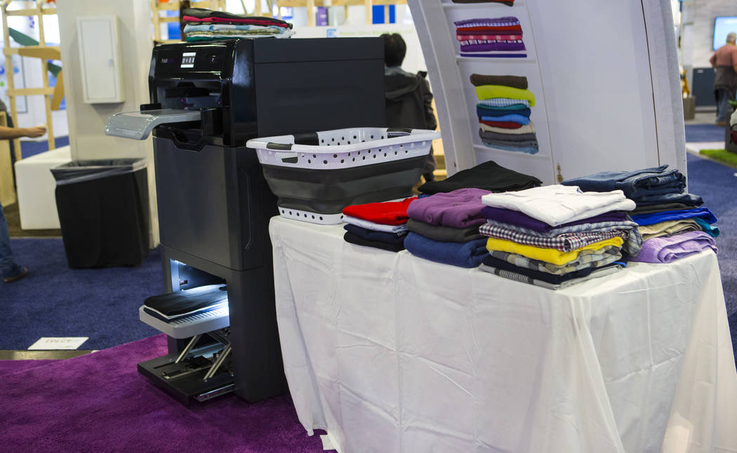 Laundry-folding robot Foldimate, left, on display at the Sands Expo and Convention Center durin ...