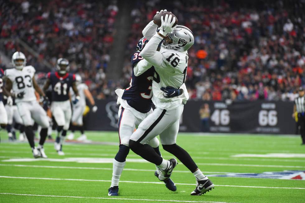 Oakland Raiders wide receiver Tyrell Williams (16) is hit by Houston Texans defensive back Keio ...