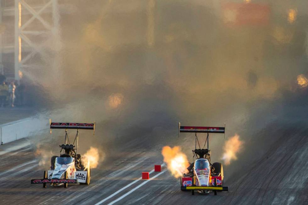 Top Fuel racers Steve Torrence and Brittany Force stay close during the final round of the Dodg ...