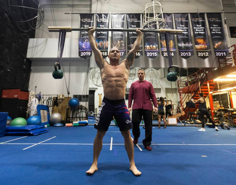Gymnast Mirek Niepielski, left, does overhead squats under the supervision of Steve McCauley, h ...