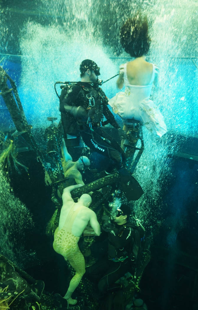 Eleven divers assist artists and change elements during performances, left, while 70 hookah reg ...