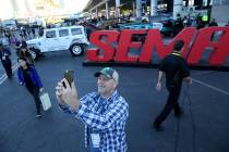 David Fortuna of North Branch, Minn. takes a selfie at the Specialty Equipment Market Show at t ...