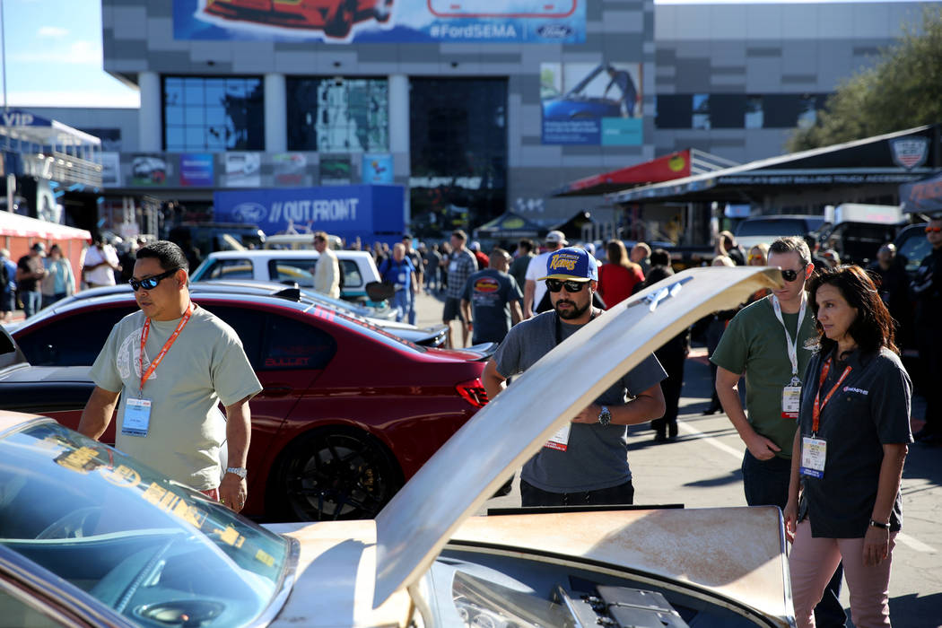 Aaron Sakahara of Sacramento, Calif., left, shows his 1959 Buick Invicta to Michael Anderson of ...
