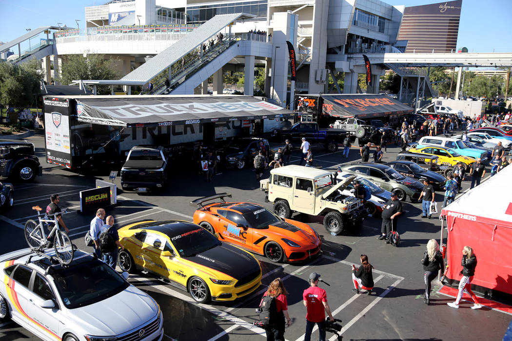 Conventioneers check out cars at the Specialty Equipment Market Show at the Las Vegas Conventio ...