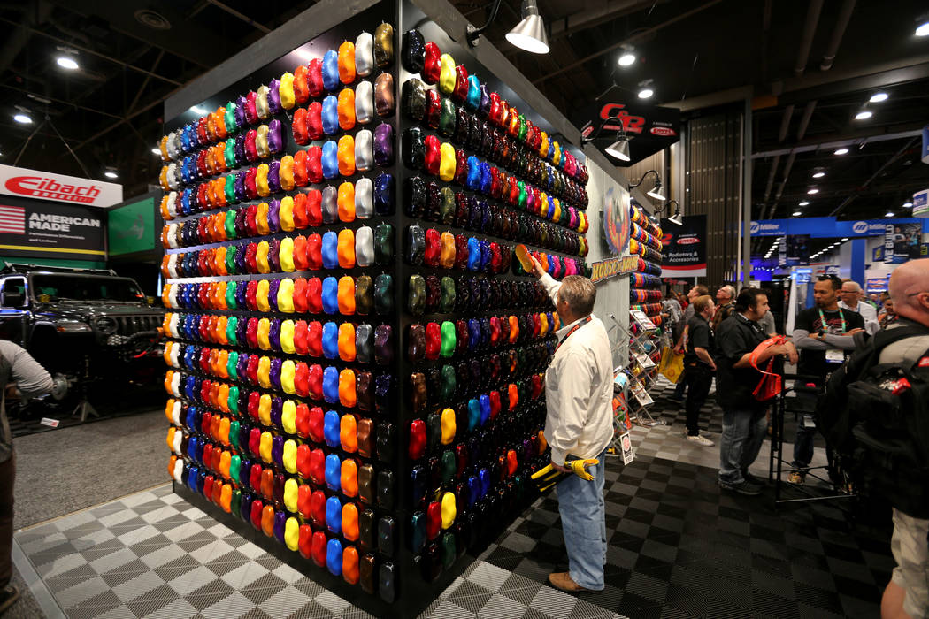 Gary Grubb of Fairfield, Ohio, looks for a color for his car at the House of Kolor booth at the ...