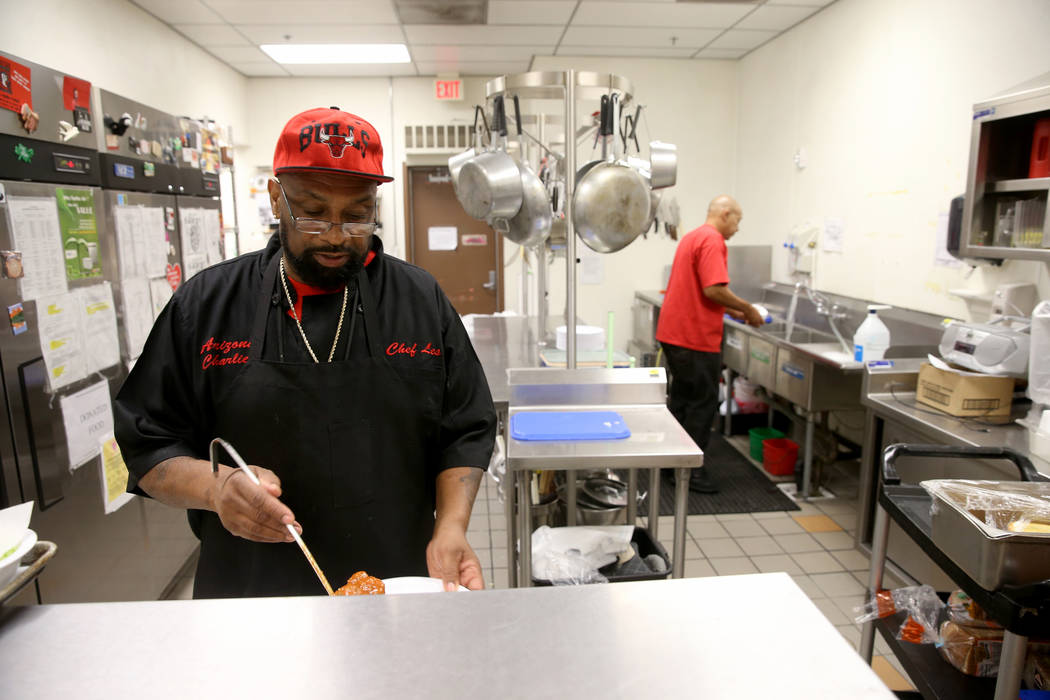 Les Johnson dishes up lunch at Martin Luther King Jr. Senior Center in North Las Vegas Wednesda ...