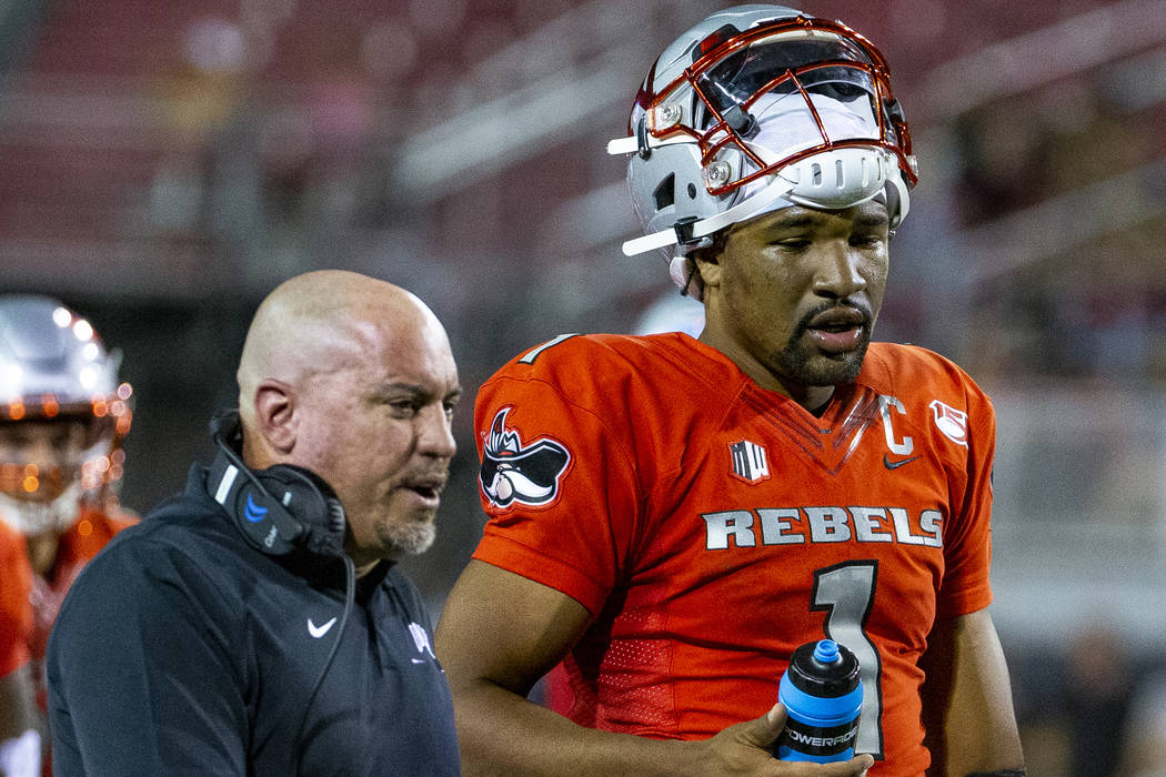 UNLV Rebels head coach Tony Sanchez talks with quarterback Armani Rogers (1) after the first qu ...