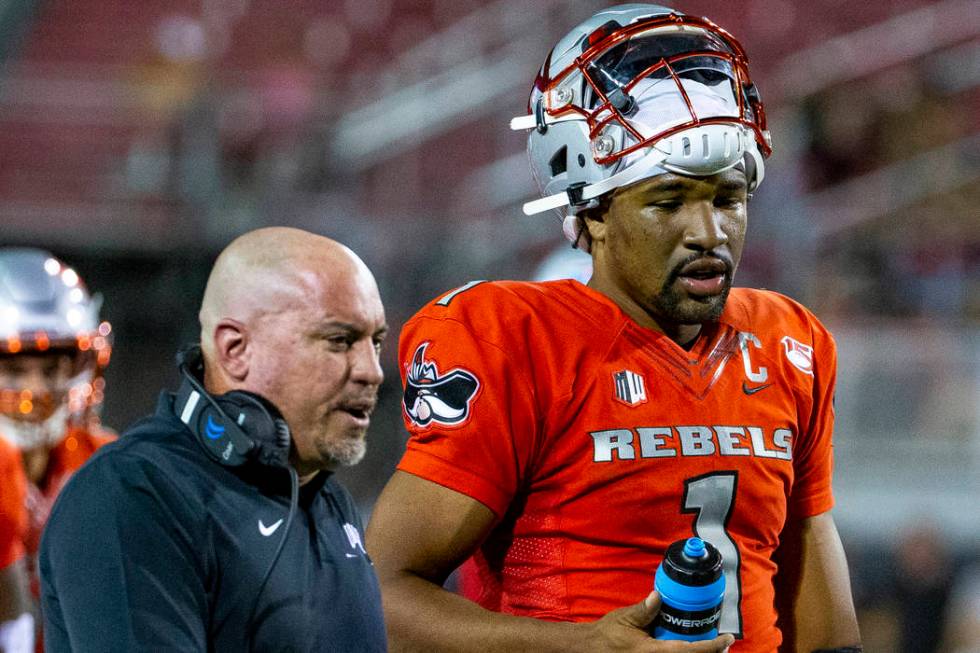 UNLV Rebels head coach Tony Sanchez talks with quarterback Armani Rogers (1) after the first qu ...