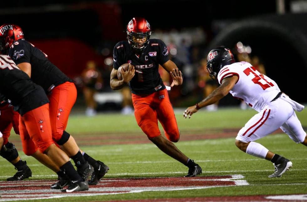 UNLV Rebels quarterback Armani Rogers (1) runs past Arkansas State Red Wolves linebacker Caleb ...