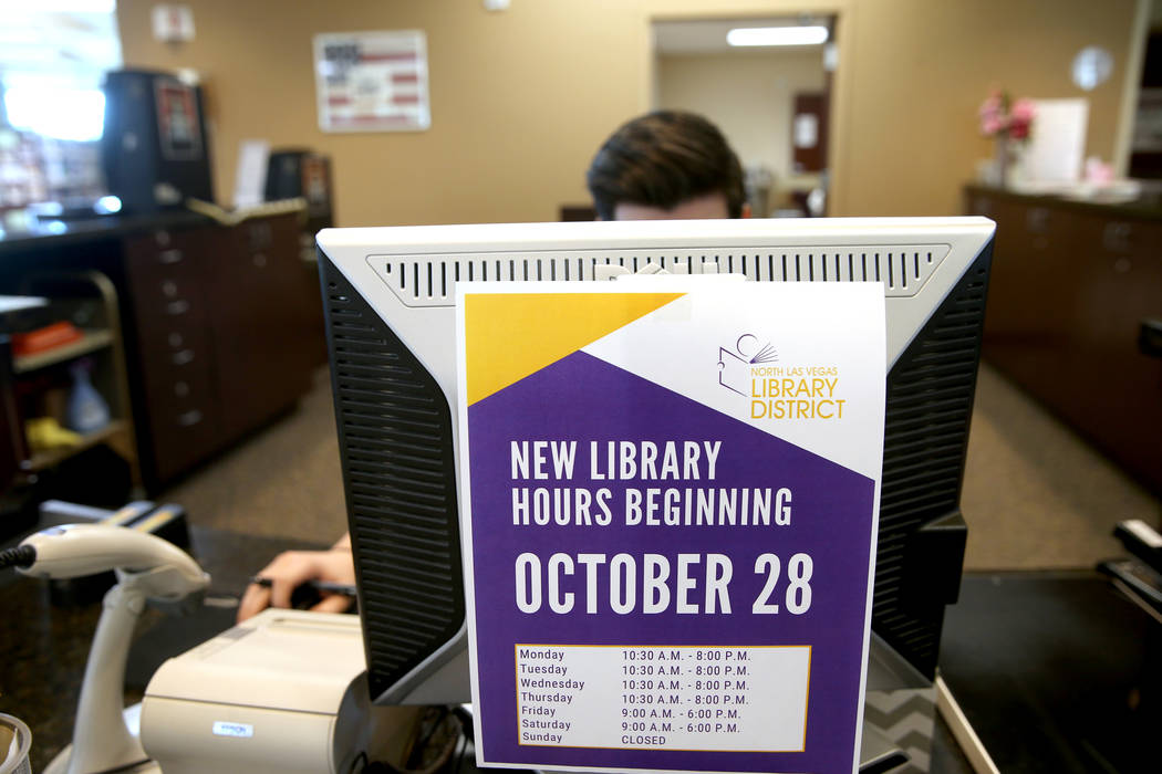New hours are displayed at Alexander Library in North Las Vegas Friday, Nov. 1, 2019. (K.M. Can ...