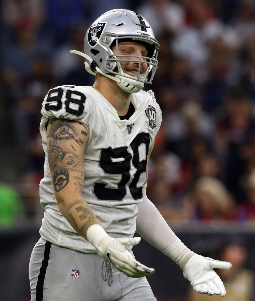 Oakland Raiders defensive end Maxx Crosby (98) gestures after being penalized for roughing the ...