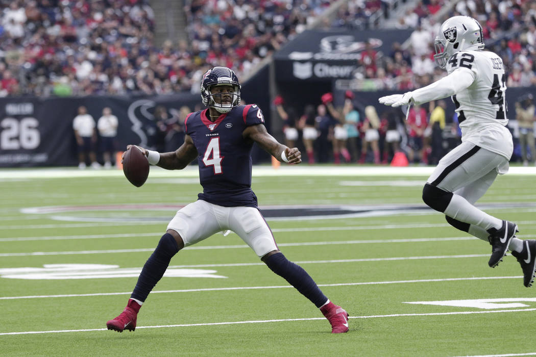 Houston Texans quarterback Deshaun Watson (4) is pressured by Oakland Raiders free safety Karl ...