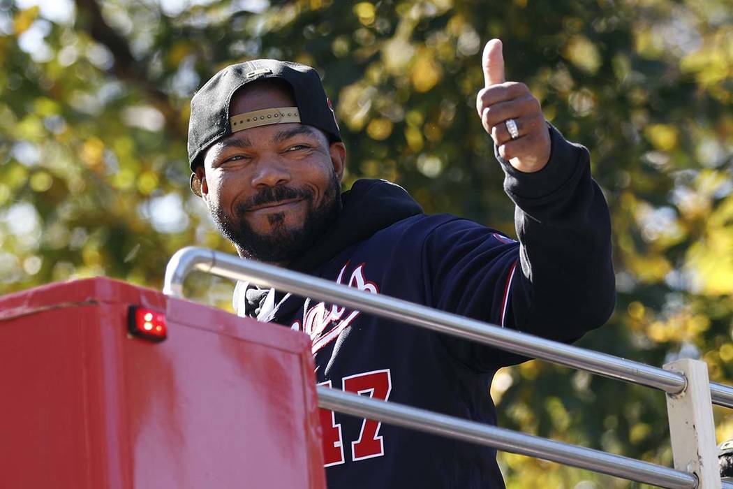 Washington Nationals second baseman Howie Kendrick gestures to fans before a parade to celebrat ...