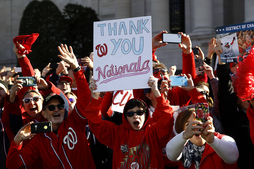 Washington Nationals fans cheer during a parade to celebrate the team's World Series baseball c ...