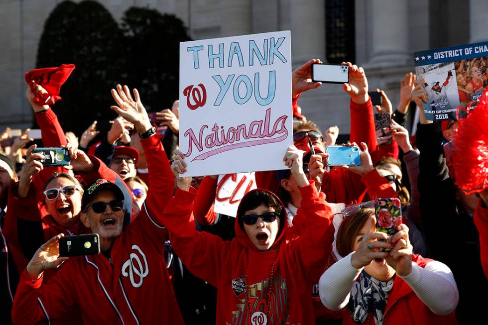 Washington Nationals fans cheer during a parade to celebrate the team's World Series baseball c ...