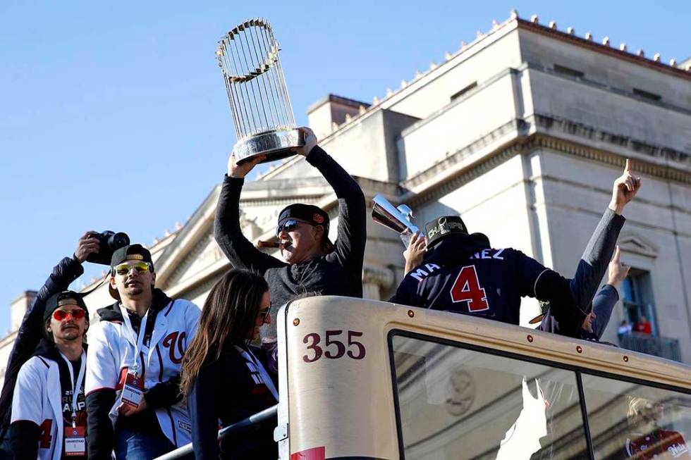 Washington Nationals general manager Mike Rizzo holds up the World Series trophy during a parad ...