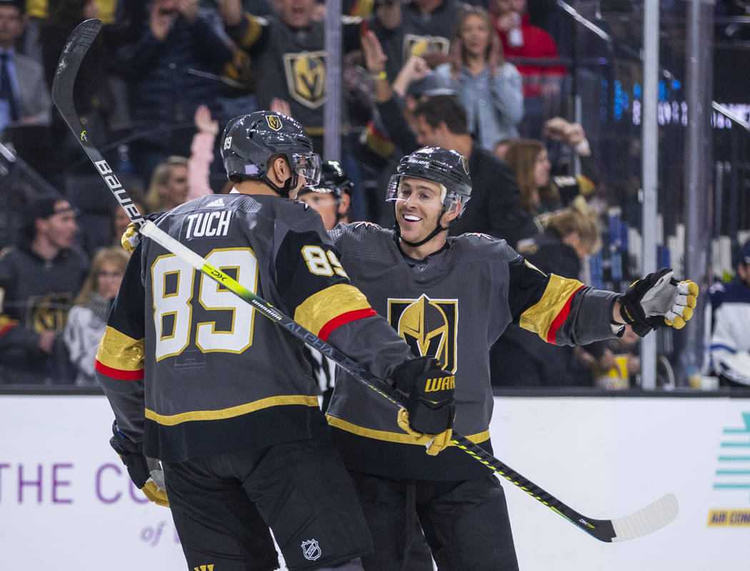 Vegas Golden Knights right wing Alex Tuch (89) comes in to celebrate a goal by center Jonathan ...