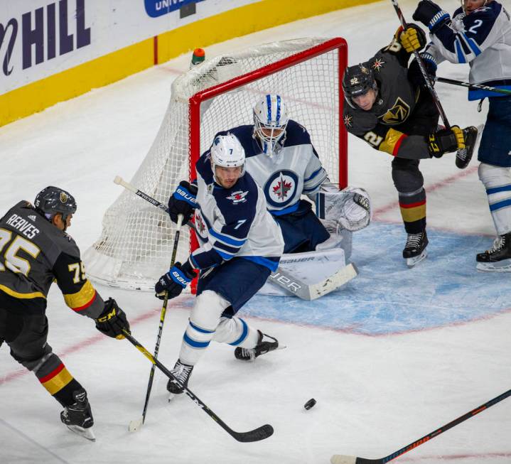 Vegas Golden Knights right wing Ryan Reaves (75) gets off a shot past Winnipeg Jets defenseman ...