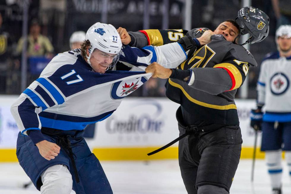 Winnipeg Jets left wing Adam Lowry (17) and Vegas Golden Knights right wing Ryan Reaves (75) sc ...