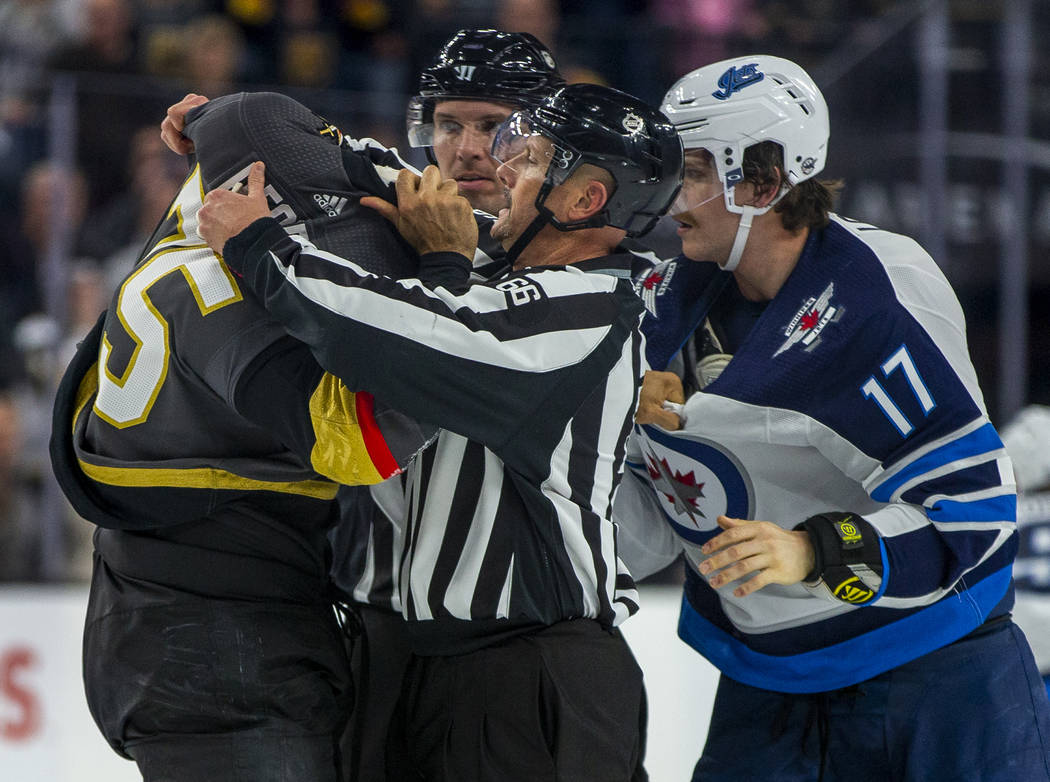 Vegas Golden Knights right wing Ryan Reaves (75) gets help with his jersey from a linesman afte ...