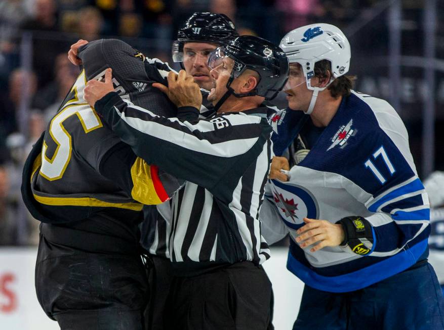 Vegas Golden Knights right wing Ryan Reaves (75) gets help with his jersey from a linesman afte ...