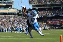 Oakland Raiders cornerback Daryl Worley, obscured, intercepts a pass intended for Detroit Lions ...