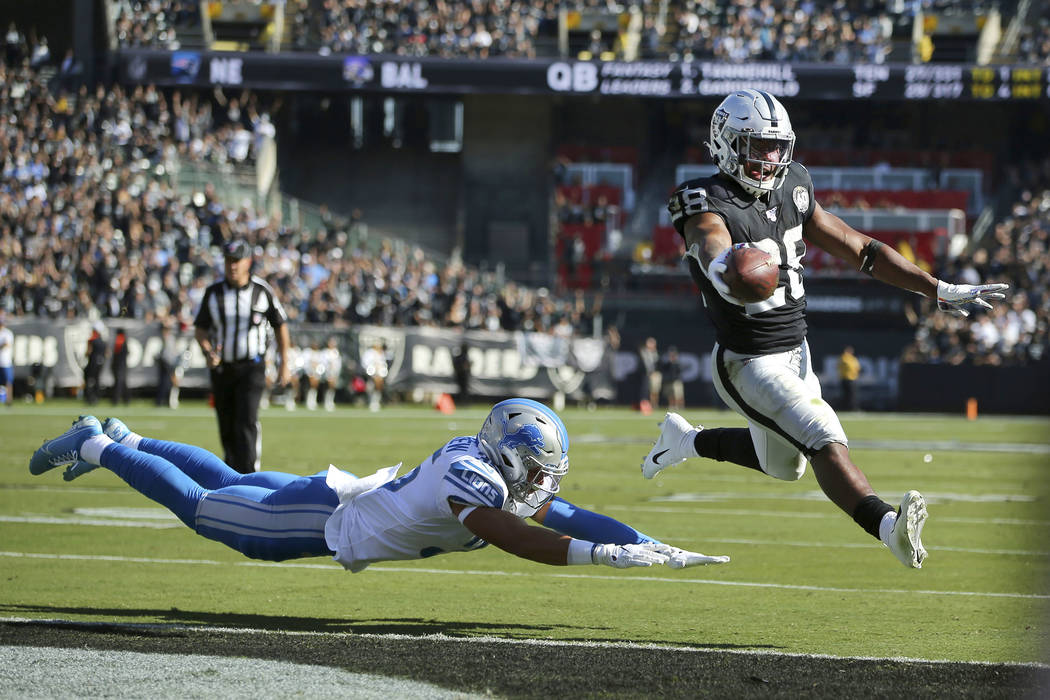 Oakland Raiders running back Josh Jacobs (28) runs for a touchdown past Detroit Lions defensive ...