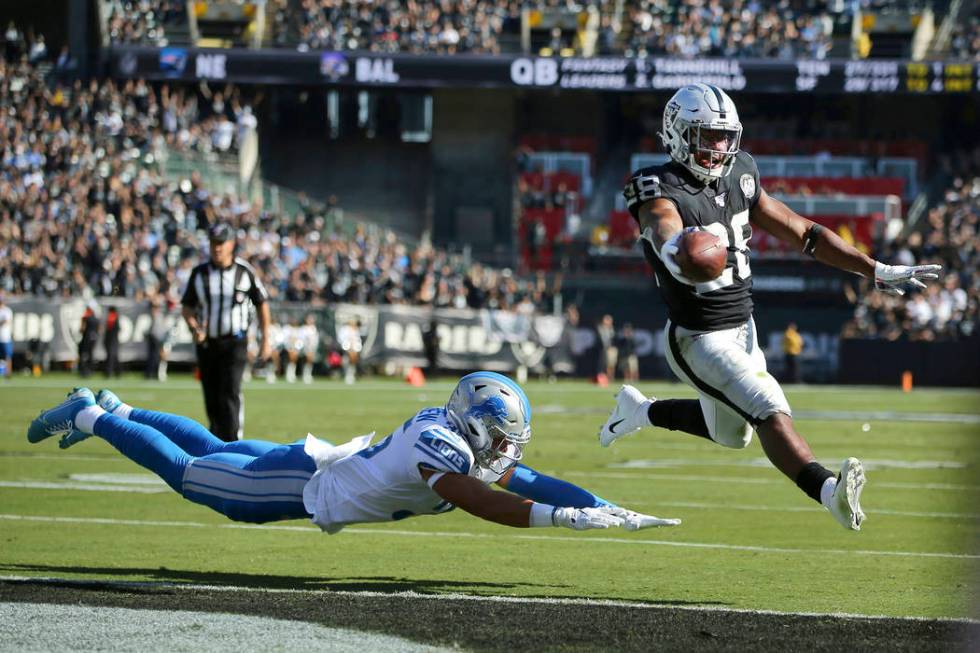 Oakland Raiders running back Josh Jacobs (28) runs for a touchdown past Detroit Lions defensive ...