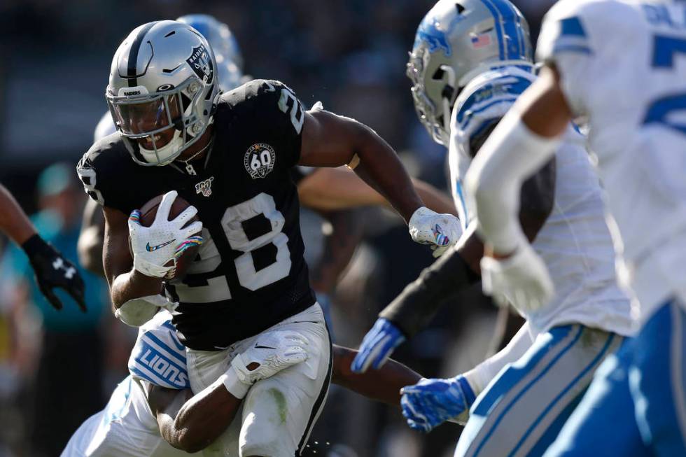 Oakland Raiders running back Josh Jacobs (28) runs against the Detroit Lions during the first h ...