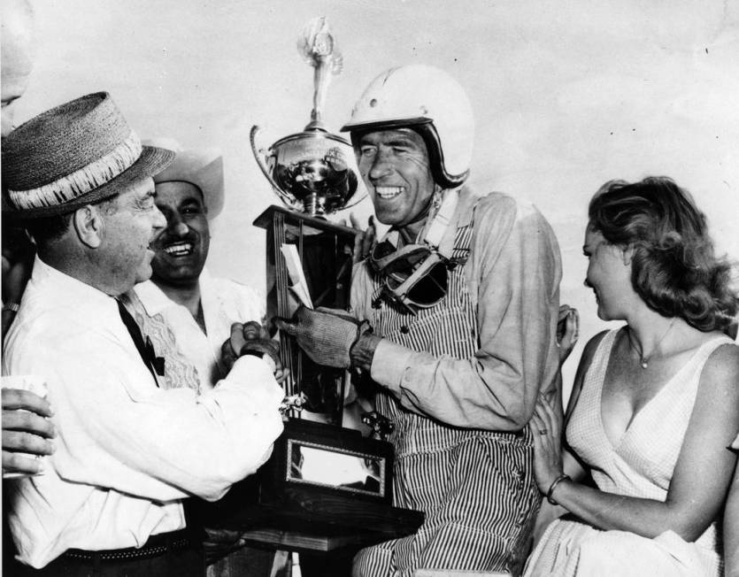 FILE - In this April 3, 1960 file photo, race car driver Carroll Shelby, center, of Dallas, rec ...