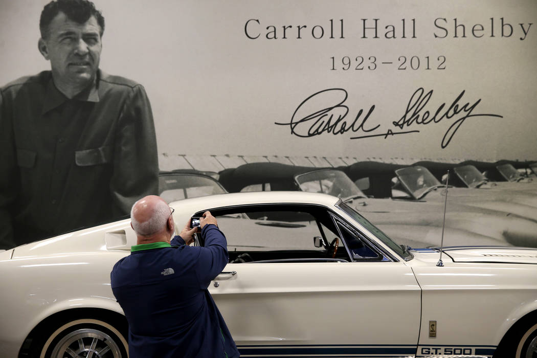 Ray Crawford of Rochester, N.Y., takes a photo of Carroll Shelby's original 1967 Super Snake GT ...