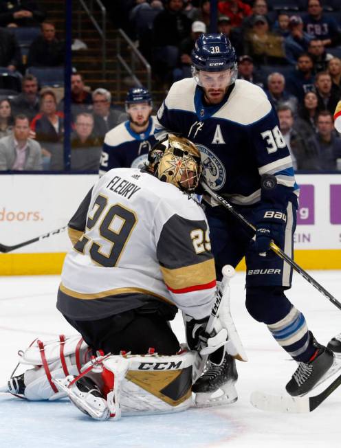 Vegas Golden Knights goalie Marc-Andre Fleury, left, stops a shot in front of Columbus Blue Jac ...