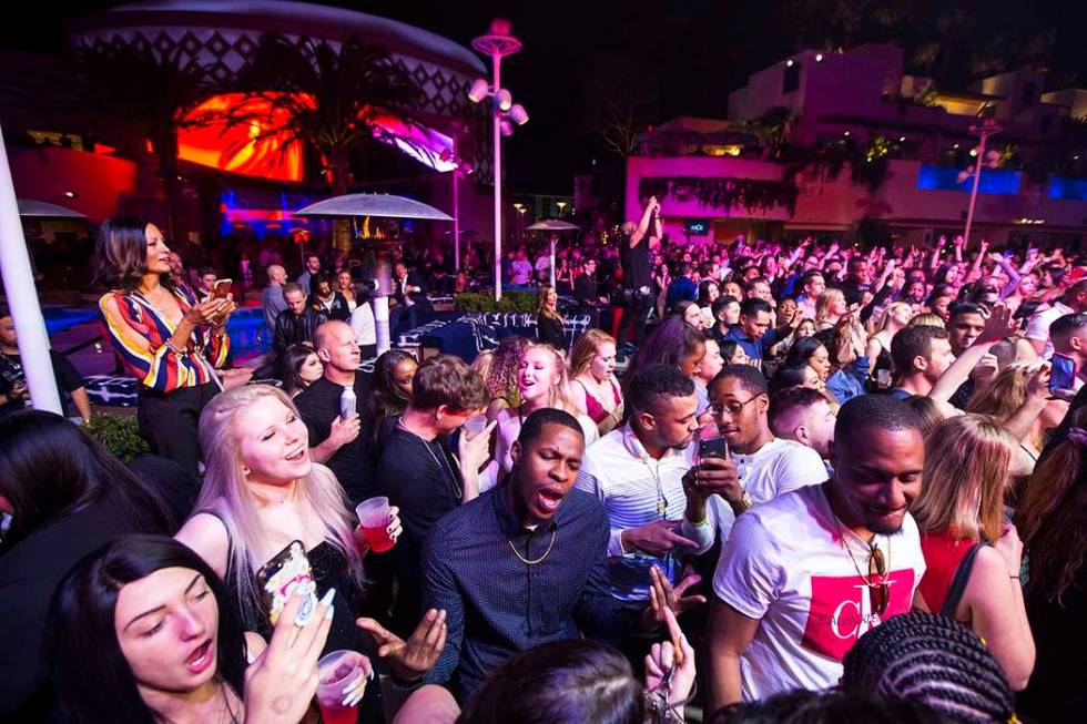 Attendees dance and listen to music as performers entertain by the outdoor stage during the gra ...