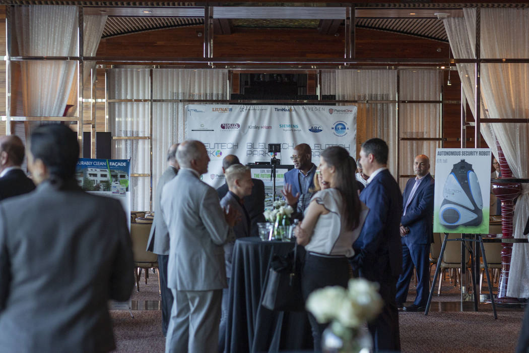 Individuals mingle during the project overview for Bleutech Park Las Vegas, the proposed $7.5 b ...
