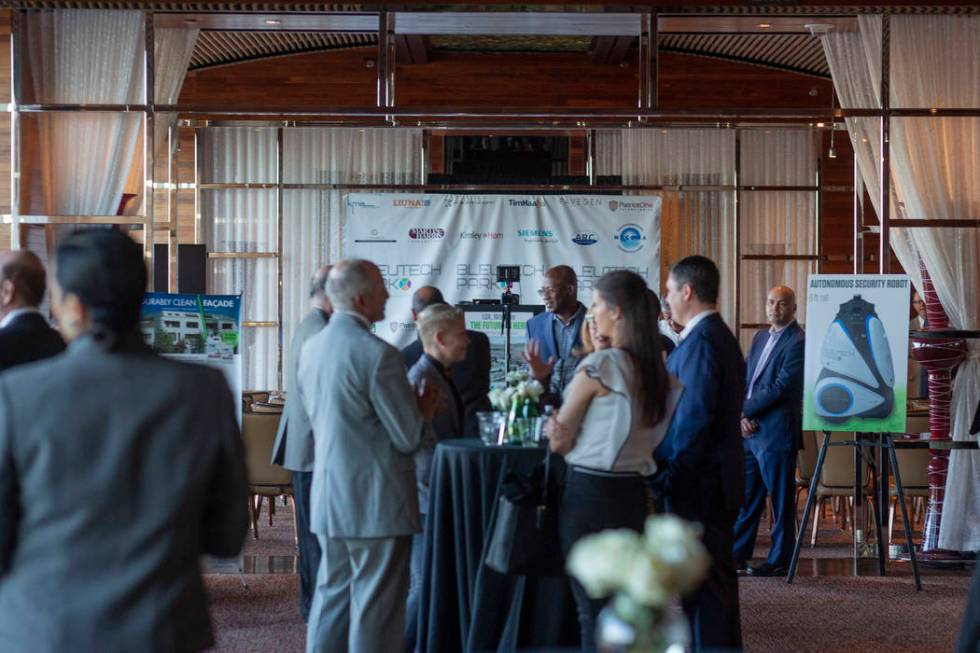 Individuals mingle during the project overview for Bleutech Park Las Vegas, the proposed $7.5 b ...