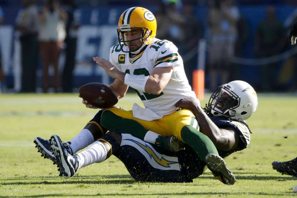 Green Bay Packers quarterback Aaron Rodgers is sacked by Los Angeles Chargers defensive end Mel ...