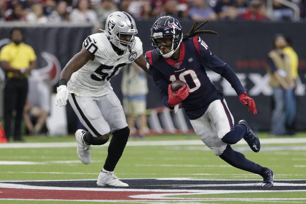 Houston Texans wide receiver DeAndre Hopkins (10) runs around Oakland Raiders linebacker Nichol ...