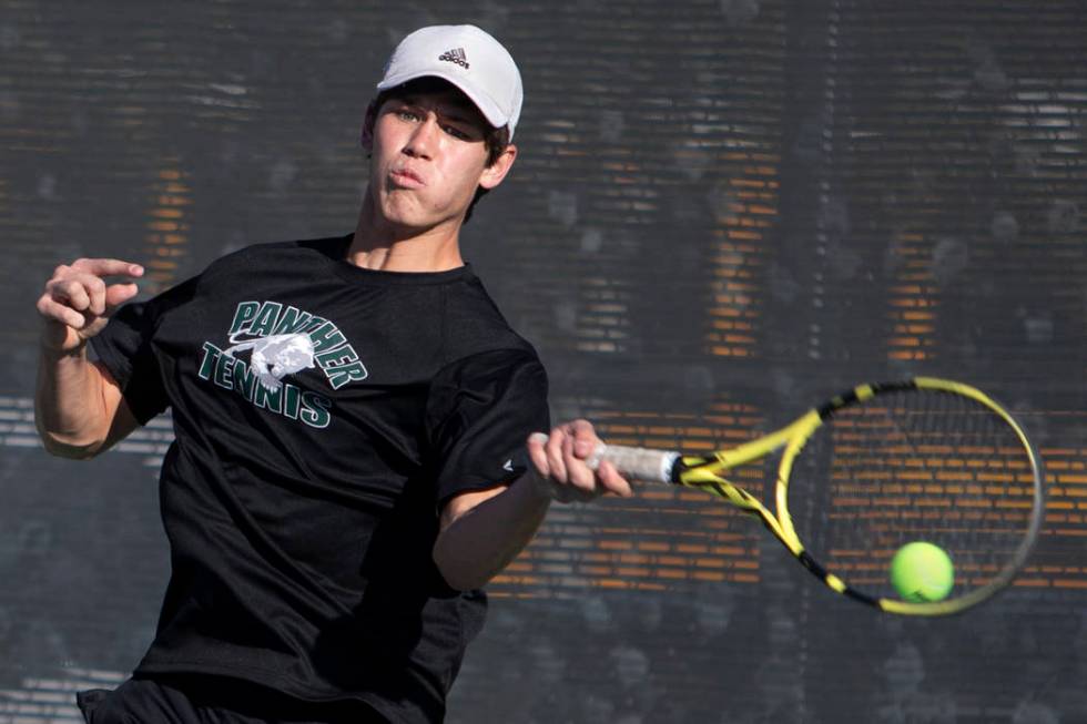 Palo Verde singles player Michael Andre hits the ball while playing Coronado's Tanner Phillips ...