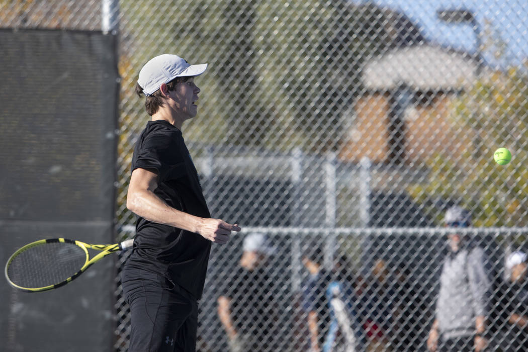Palo Verde singles player Michael Andre jumps to hit the ball while playing Coronado's Tanner P ...