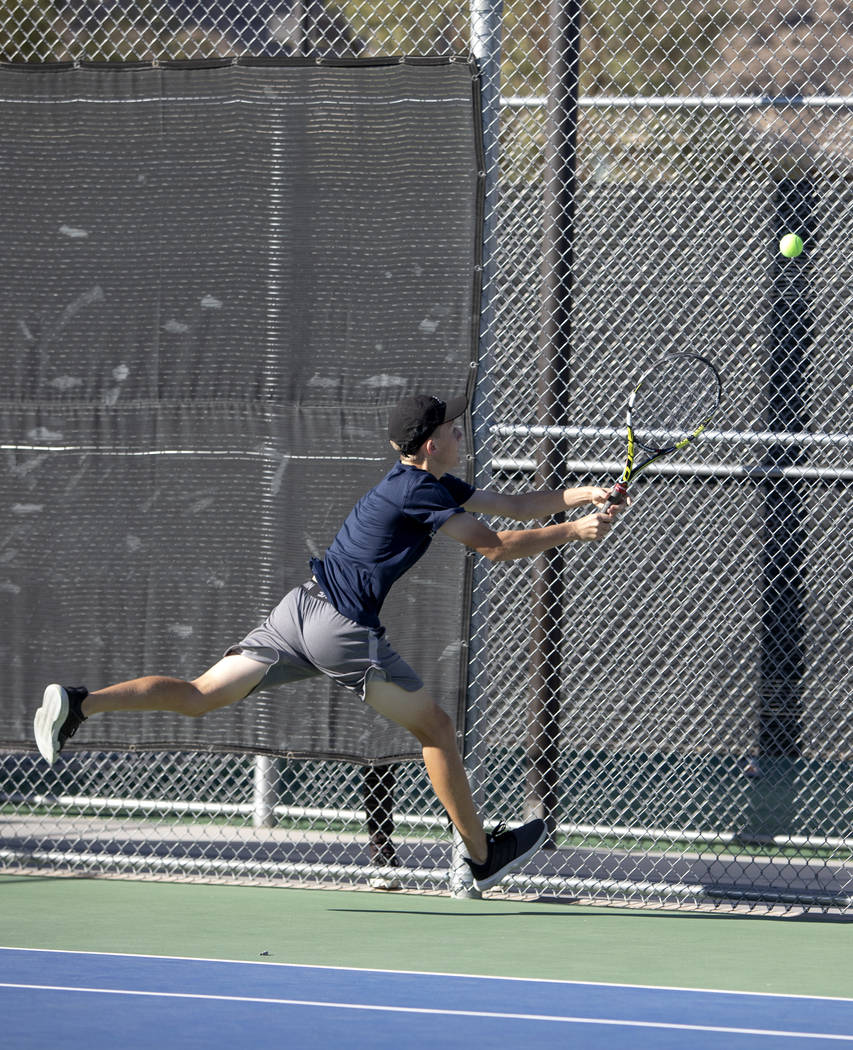 Coronado High School's Jonah Blake reaches for the ball during a doubles match with his partner ...