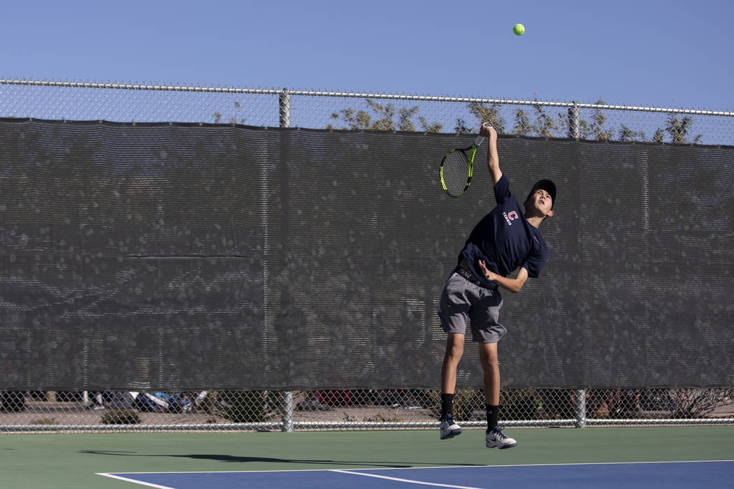Coronado's Jack Wohlwend serves during a doubles match against Palo Verde High School on Wednes ...