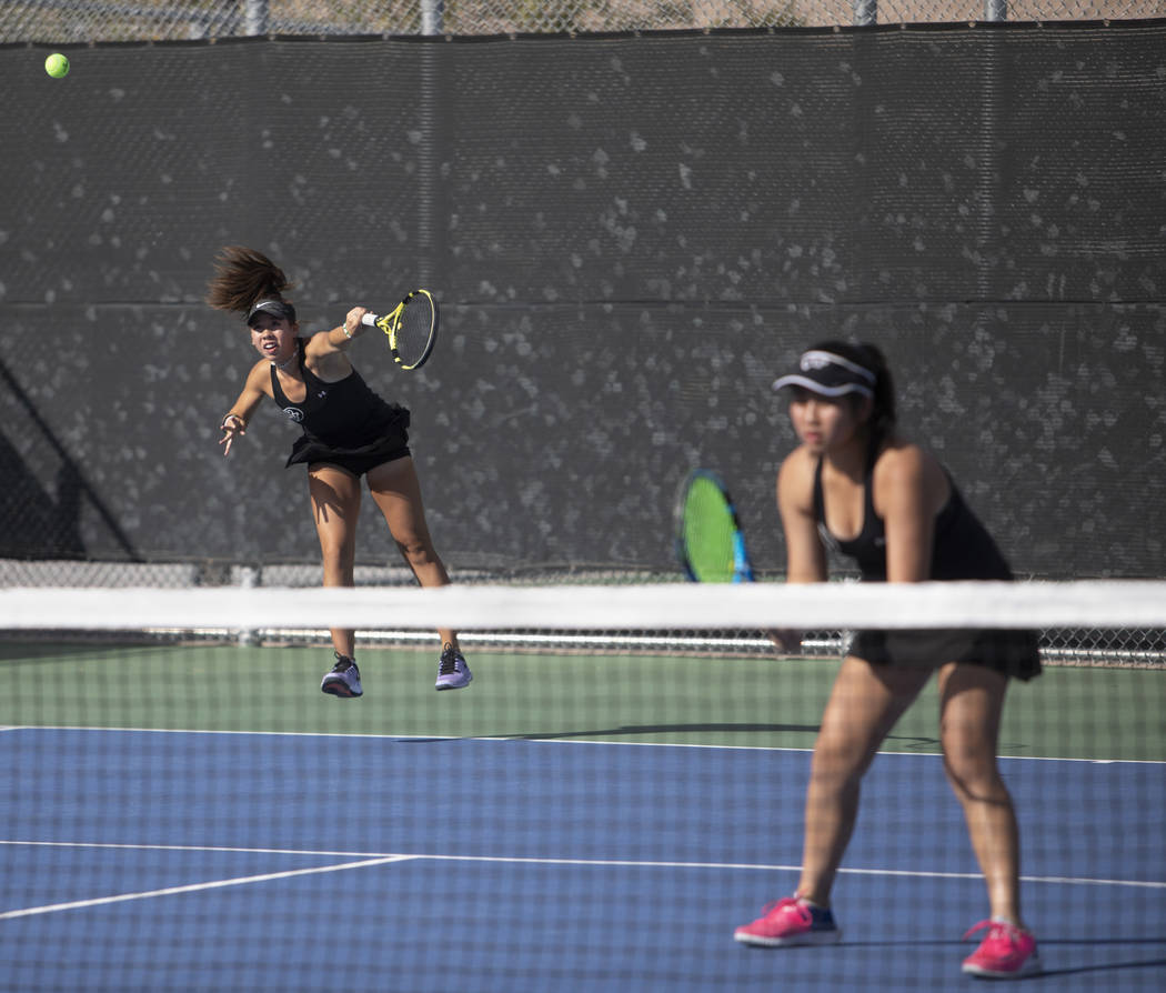 Palo Verde's Roxy Okano serves during a doubles match against Coronado's Sofia Potamitis and Av ...