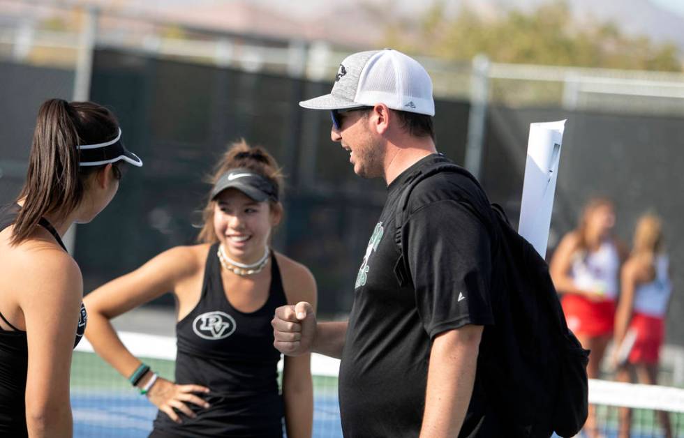 Palo Verde women's varsity tennis coach Tyler Marchant, right, encourages players Caroline Hsu, ...
