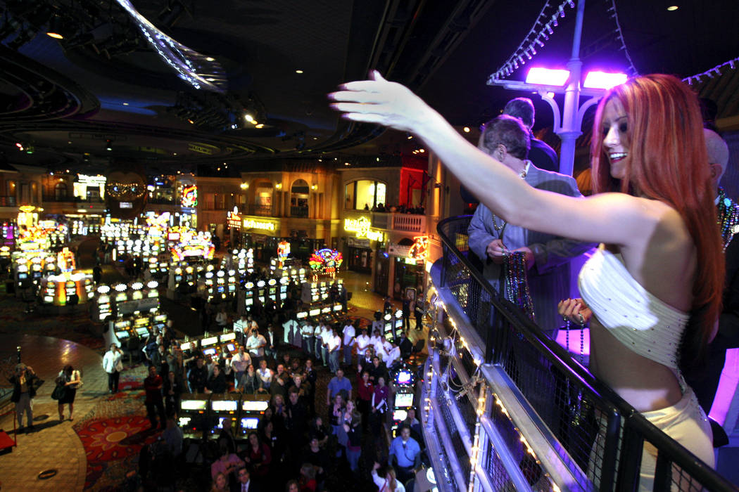 JOHN GURZINSKI/LAS VEGAS REVIEW-JOURNAL Customers and employees riding a float throw beads to g ...