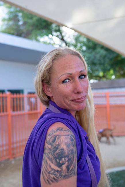 Nicole Fox, an enrichment specialist for the Animal Foundation, shows off her pitbull tattoo at ...