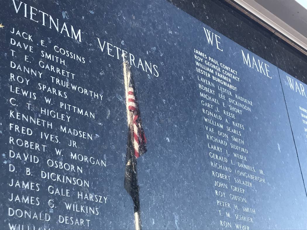 A reflection of the American flag is seen Nov. 7 on a Vietnam veterans panel on Henderson’s V ...